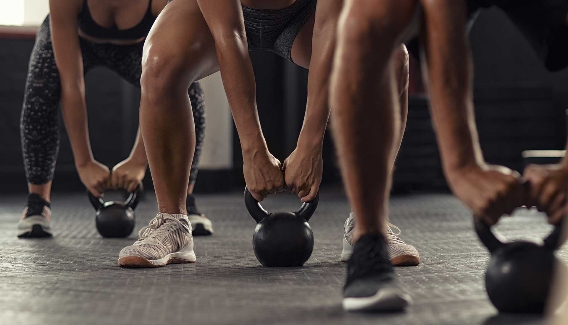 Athlete people doing weight lifting with kettlebell.