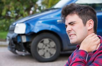 Male Motorist Suffering From Whiplash Pain After Car Accident