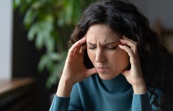 A woman suffering from a tension headache.